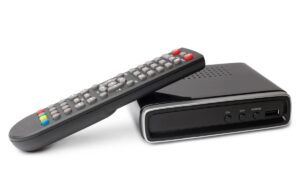 Digital TV tuner with remote control on white background